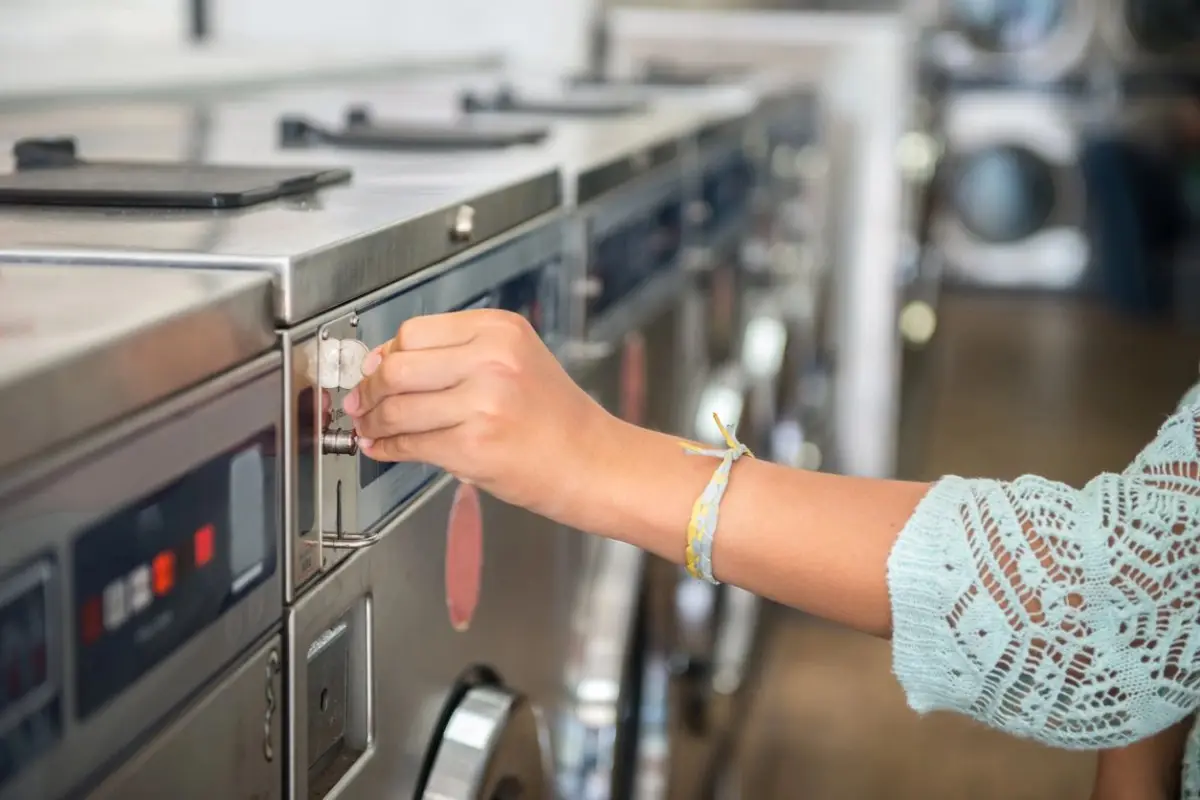 a hand inserting coin